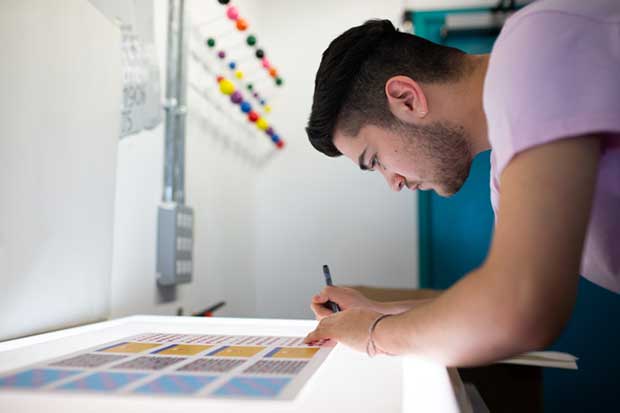 man at white board